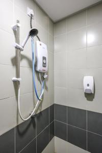a shower in a bathroom with a blue hose at Premium Look Homestay in emerald avenue apartment Clover Home 5-06 in Brinchang +17 photos