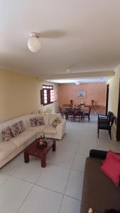 a living room with a couch and a table at Casa de praia em Maria Farinhaa - Paulista in Paulista