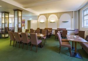 a dining room with tables and chairs at Aspire Frankfurt Airport, Trademark Collection by Wyndham in Rüsselsheim