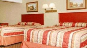 Кровать или кровати в номере Travelodge by Wyndham Bay Shore Long Island
