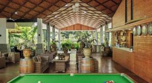 a pool table in the middle of a room at Orator Hotel in Apia