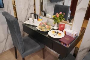 a black desk with a plate of food on it at Envoy Express, Islamabad in Islamabad