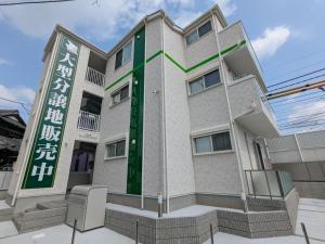a building with a sign in front of it at Vacation House 3 in Funabashi