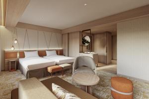 a hotel room with two beds and a couch at Mitsui Garden Hotel Sapporo in Sapporo