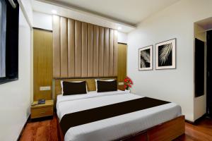 プネにあるSuper Townhouse Viman Nagar Business Stay Formerly Silver Crestの部屋の中に大きなベッドがある寝室