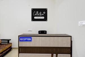 a reception desk in a room with a sign at Collection O Adibatla X Road, Near TCS, Wonderla Road in Ibrāhīmpatan