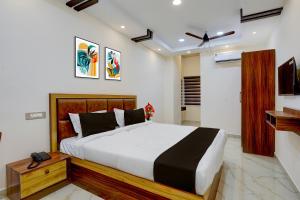 a bedroom with a large bed and a television at Townhouse Guduvancheri Junction Formerly Zafe Commercial in Madambakkam