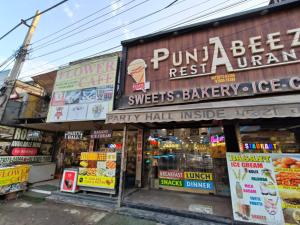 a store with signs on the side of a building at Punjabeez Restaurant in Patiāla