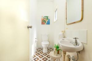 a bathroom with a sink and a toilet at Anchor Down in Yamba +19 photos