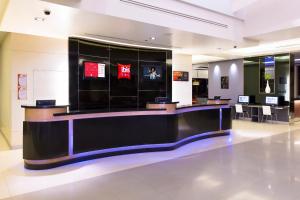 a large lobby with a counter in a store at Ibis Bangkok Sukhumvit 4 in Bangkok