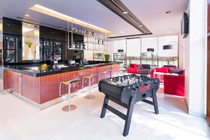 a kitchen with a ping pong table in a room at Ibis Bangkok Sukhumvit 4 in Bangkok