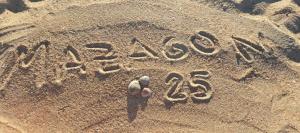 a sign written in the sand on the beach at Casa Mazagón con vistas al mar in Mazagón
