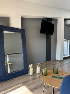 a living room with a mirror and a table at Двухуровневая квартира в центре in Kharkiv