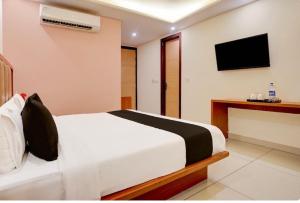 una habitación de hotel con una cama y un televisor en Hotel O ATR Residency, en Nueva Delhi