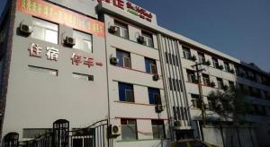 a building with writing on the side of it at Shell Hotel Taiyuan South Railway Station New Southeast Bus Station in Taiyuan