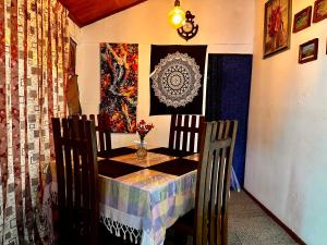 a dining room table with a table and chairs at Cozy Heaven in Nuwara Eliya