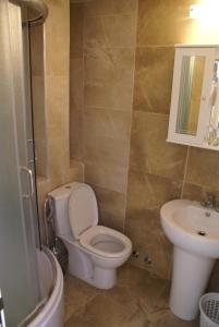 a bathroom with a toilet and a sink at Hotel Obala in Budva