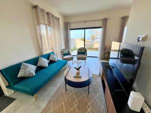 a living room with a blue couch and chairs at Entire villa with private pool and seaview Albion Mauritius in Albion