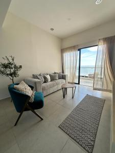 a living room with a couch and a chair at Relax with panoramic ocean and city views in Mazatlán