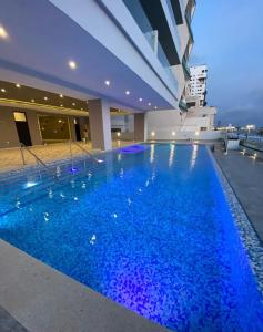 a swimming pool in a building with blue water at Relax with panoramic ocean and city views in Mazatlán