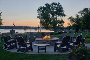 a fire pit with chairs and a table and a fire place at Hotel Canandaigua, Tapestry Collection By Hilton in Canandaigua