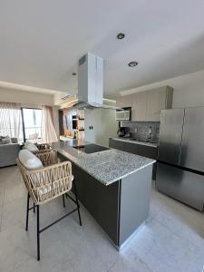 a kitchen with a counter and a chair in a room at Relax with panoramic ocean and city views in Mazatlán
