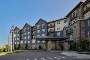 an apartment building with a parking lot in front at Hotel Canandaigua, Tapestry Collection By Hilton in Canandaigua