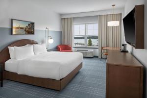 a hotel room with a bed and a desk at Hotel Canandaigua, Tapestry Collection By Hilton in Canandaigua +108 photos