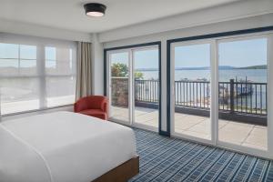 a bedroom with a bed and a view of the ocean at Hotel Canandaigua, Tapestry Collection By Hilton in Canandaigua