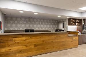 a lobby with a counter with two laptops on it at Country Inn & Suites by Radisson, Lake Norman Huntersville, NC in Huntersville