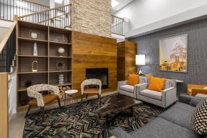 a living room with furniture and a fireplace at Country Inn & Suites by Radisson, Lake Norman Huntersville, NC in Huntersville