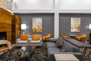 a lobby with couches and chairs and a fireplace at Country Inn & Suites by Radisson, Lake Norman Huntersville, NC in Huntersville +118 photos