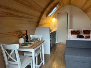 a room with a table and a room with a bed at Westfield House in Gargrave