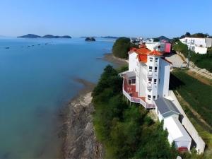 an aerial view of a house next to the water at Gallery Pension in Taean