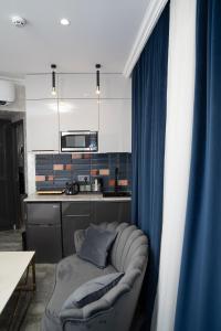 a living room with a couch in a kitchen at Prime Suites Hotel in Yerevan
