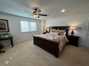 a bedroom with a bed and a ceiling fan at Destination #16 in Anaheim +34 photos