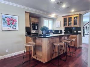 a kitchen with a island with bar stools at Destination #16 in Anaheim