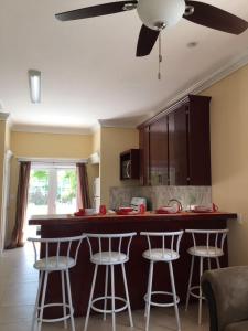 a kitchen with a counter and bar stools at Mangrove Cay Sea View Villas in Behring Point