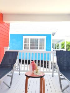 a patio with two chairs and a table on a porch at Mangrove Cay Sea View Villas in Behring Point