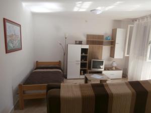 a bedroom with two beds and a desk with a computer at Apartment Gabi in Labin