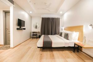 Postel nebo postele na pokoji v ubytování Townhouse Oak Cochin International Airport