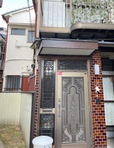 a front door of a house with a gate at 望月ハウス101 in Tokyo