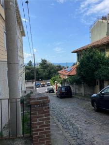 a street with cars parked on the side of a building at Pretty Favetti - lovely apartment in Trieste with a sea view - in Trieste