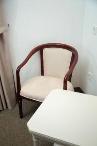 a wooden chair in a room with a table at Qyzylorda Hotel in Kyzylorda +39 photos
