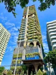 a tall building with plants on the side of it at The Signature Hotel Nha Trang in Nha Trang