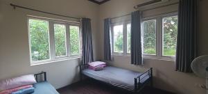 a room with a bed in a room with windows at 88 Ehome Noibai Airport in Hanoi