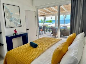 a bedroom with a bed with a view of the ocean at Backyard Beach House Oceanfront Luxury 5 Bdr in Playa Hermosa +78 photos
