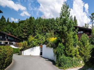 a white fence next to a road with trees at Double room in Saalfelden by the Steinernes Meer in Saalfelden am Steinernen Meer
