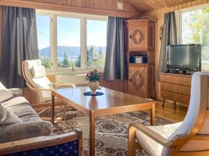 a living room with a table and a tv at 3 person holiday home in Frei-By Traum in Frei