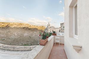 a balcony with a view of a city at I Tre Portali Luxury Suites in Matera